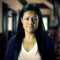 Raquel Santos Unsmiling woman with long dark hair
